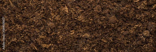 Dark brown dry soil background. Fresh ground for garden season. Wide banner. Empty place for text. Top down view.