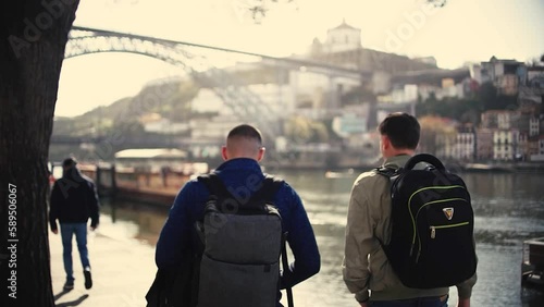 Tourist man walking though poor neiborhood narrow streets where poverty can be seen in Oporto, Portugal.