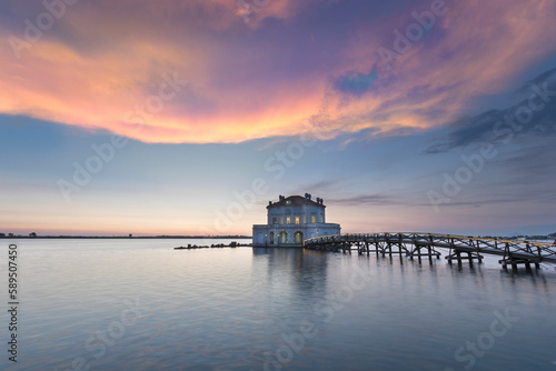 View of Fusaro Lake at sunset and the Casina Vanvitelliana, Bacoli, Naples, Italy. photo