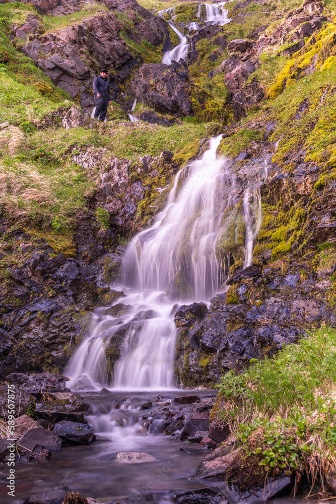 View of a waterfall with river on Unalaska Island, Unalaska, Alaska, United States. View of a waterfall with river on Unalaska Island, Unalaska, Alaska, United States.