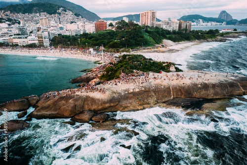 Aerial drone view of Arpoador Rock in Ipanema Beach, with Praia Vermelha visible on right, Rio de Janeiro, Brazil photo