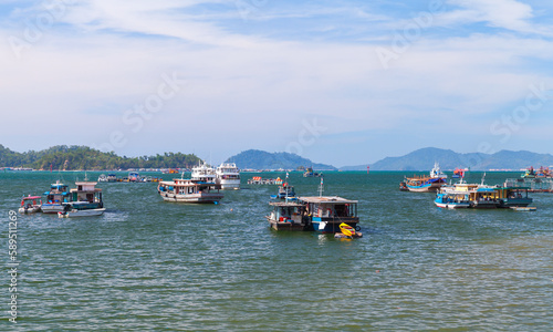 Fishing boats are moored in bay of Kota Kinabalu on a sunny day