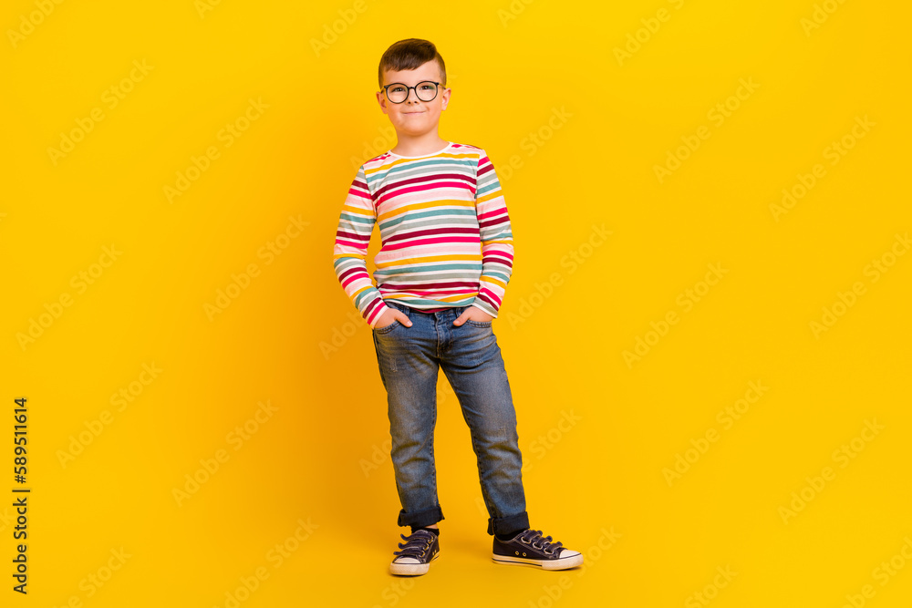 Photo of cheerful glad cute boy wear bright denim outfit promoting kid collection clothes empty space isolated on yellow color background Photo of cheerful glad cute boy wear bright denim outfit promoting kid collection clothes empty space isolated on yellow color background