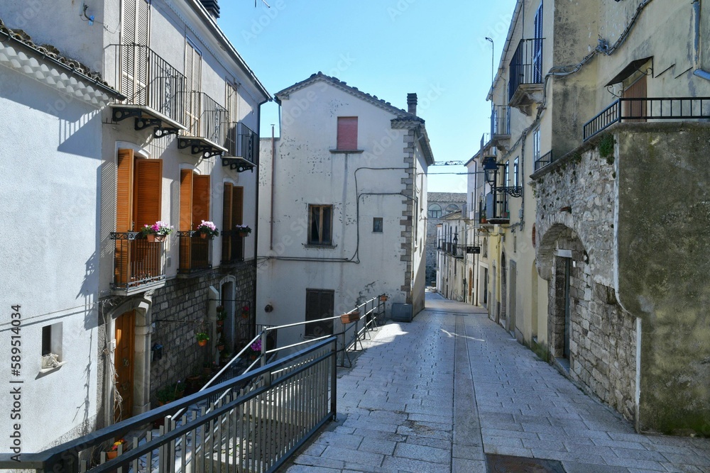 A narrow street among the old houses of Civitacampomarano, a historic town in the state of Molise in Italy.