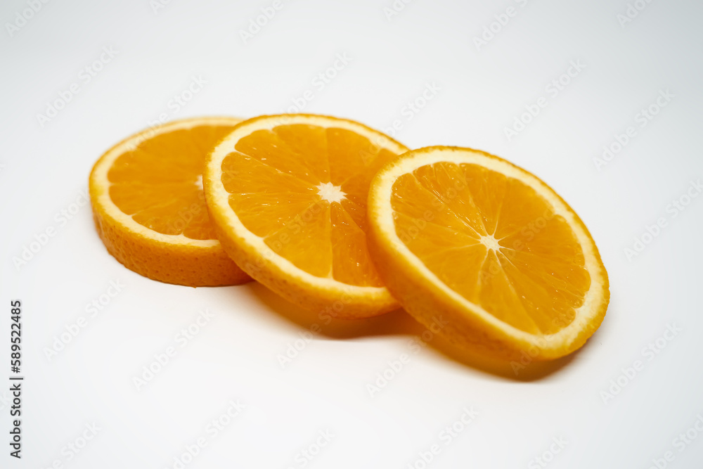 Three slices of orange on white isolated studio background side view Three slices of orange on white isolated studio background side view