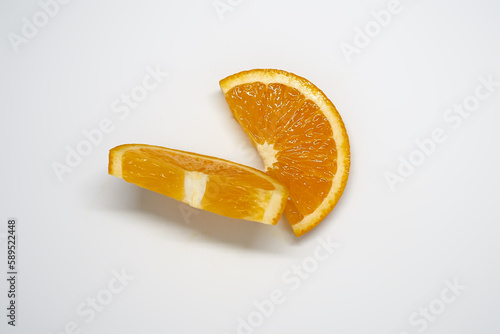 Two slices of       orange on white isolated studio background top view