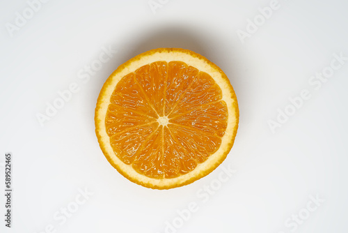 Slice of ​​orange on white isolated studio background top view