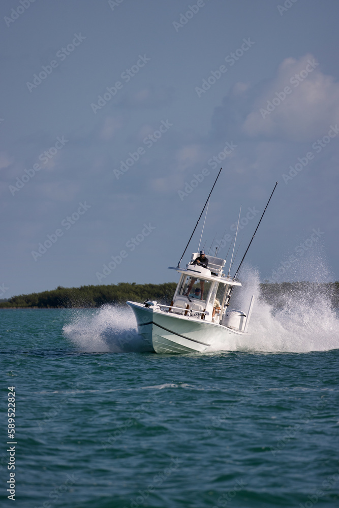 Fototapeta premium Speeding center console fishing boat throwing spray.