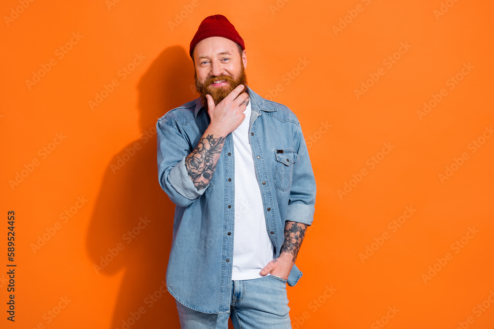 Photo of cool fashion model guy touch his beard adverrtise for clothes discount isolated vivid color background