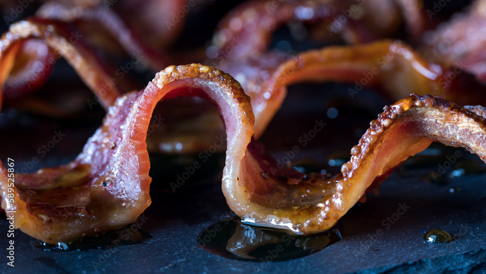 Close up of a wavy strip of maple pepper bacon, hot off the griddle. Close up of a wavy strip of maple pepper bacon, hot off the griddle.