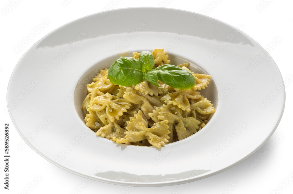 Farfalle pasta (bow tie shape) with pesto, a typical Genoese sauce of basil, pine nuts, olive oil and parmesan cheese in a white dish