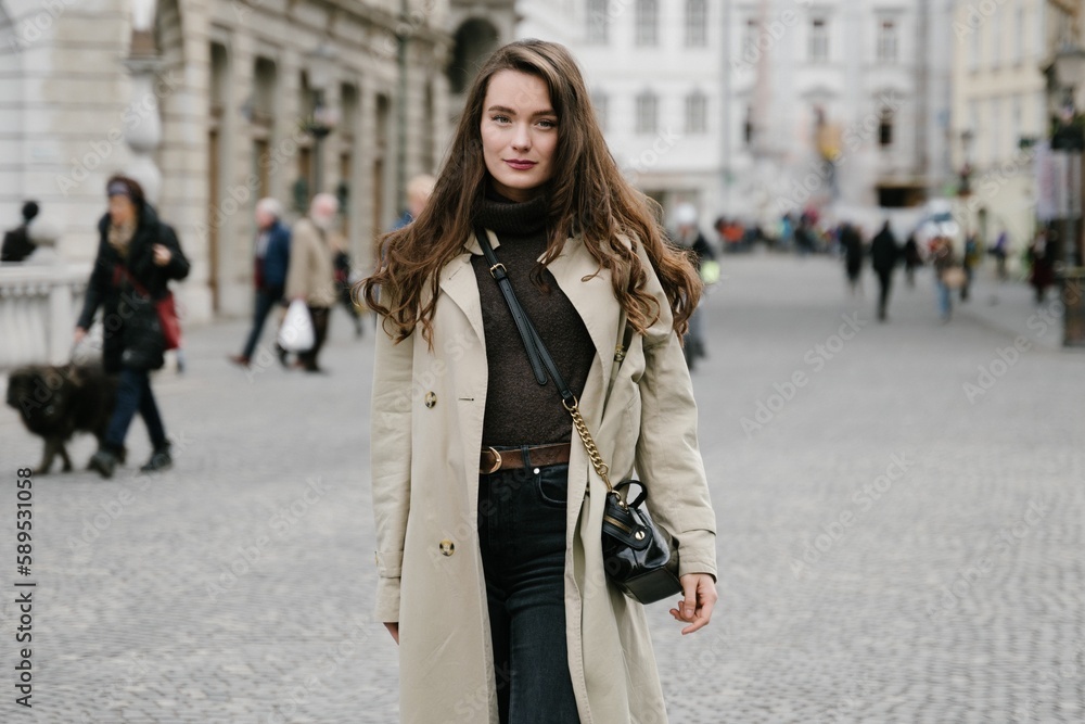 Fototapeta premium Young beatiful woman portrait in the historical city centre of Ljubljana in trendy outfit