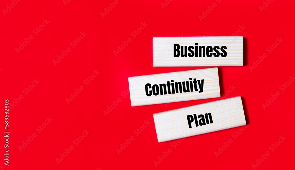 Three wooden blocks with the text BCP Business Continuity Plan on a bright red background. Copy space Three wooden blocks with the text BCP Business Continuity Plan on a bright red background. Copy space