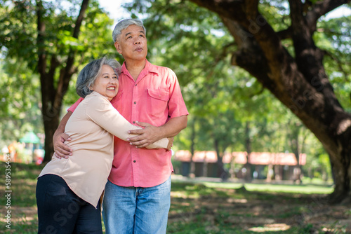 Portrait of lovely elderly couple hugging each other with love and happiness in a park outdoor. Happy smiling Elderly couple enjoying with positive emotions at garden © Prot