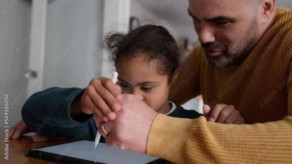 Cheerful boy with Down syndrome using digital tablet Cheerful boy with Down syndrome using digital tablet