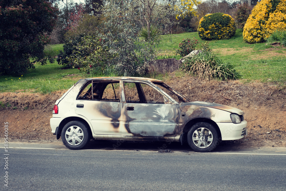 burnt out stolen car abandonded on the roadside burnt out stolen car abandonded on the roadside
