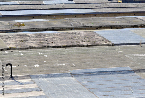 Roofing material-covered roofs of outbuildings on a spring day