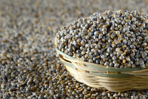 Bajra (Pearl millet) in wooden (bamboo) basket photo