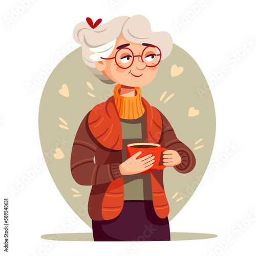 Cute elderly woman holding a cup of tea or coffee