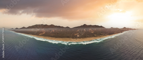 View from above, stunning panoramic view of Cofete beach surrounded by the chain of mountains of the Jandía Natural Park during a beautiful sunset. Fuerteventura, Canary Islands.