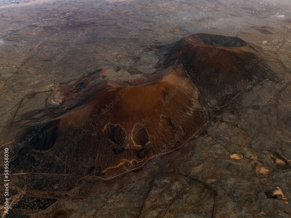 View from above, stunning aerial view of Calderon Hondo during a beautiful sunrise. Calderon Hondo is a volcanic caldera in the sland of Fuerteventura, Canary Islands.