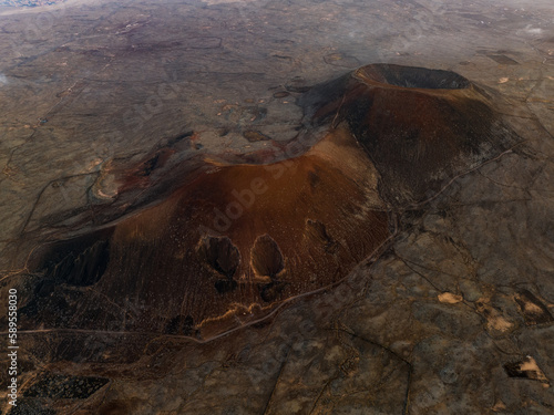 Obraz na płótnie View from above, stunning aerial view of Calderon Hondo during a beautiful sunrise. Calderon Hondo is a volcanic caldera in the sland of Fuerteventura, Canary Islands. w salonie