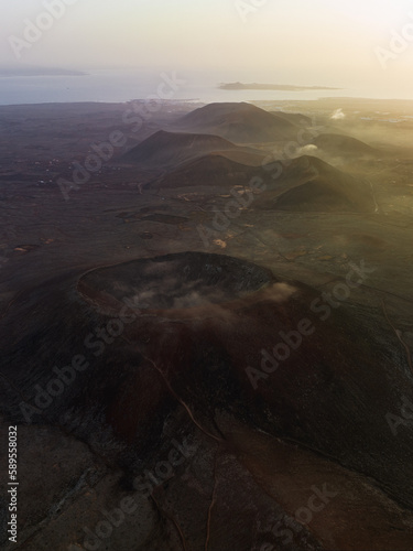 Obraz na płótnie View from above, stunning aerial view of Calderon Hondo during a beautiful sunrise. Calderon Hondo is a volcanic caldera in the sland of Fuerteventura, Canary Islands. w salonie