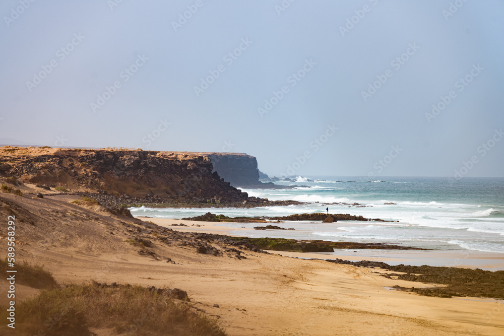 Stunning view of the El Cotillo beach with a rocky coastline in the distance. El Cotillo is situated on the northwest coast of Fuerteventura, Canary Islands, Spain.