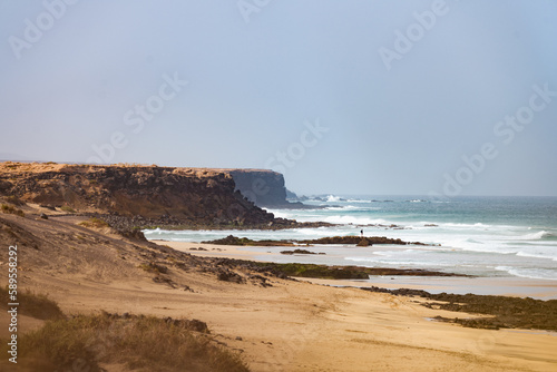 Obraz na płótnie Stunning view of the El Cotillo beach with a rocky coastline in the distance. El Cotillo is situated on the northwest coast of Fuerteventura, Canary Islands, Spain. w salonie