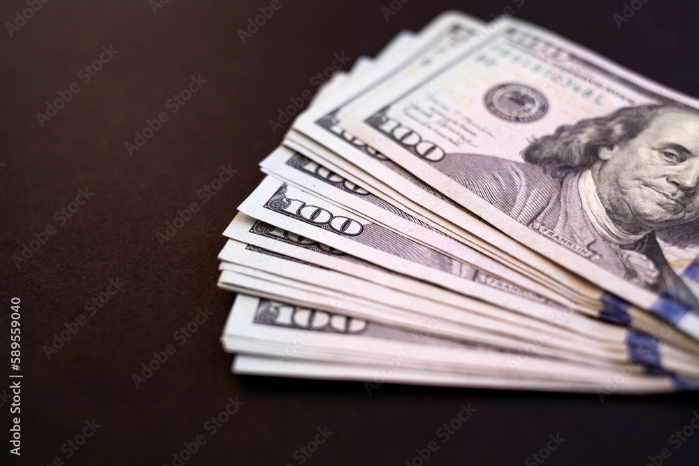 pile of one hundred US banknotes. Background with money american hundred dollar bills. 100 bills background. Lots of dollar bank notes on the table. The concept of financial business and crisis. pile of one hundred US banknotes. Background with money american hundred dollar bills. 100 bills background. Lots of dollar bank notes on the table. The concept of financial business and crisis.