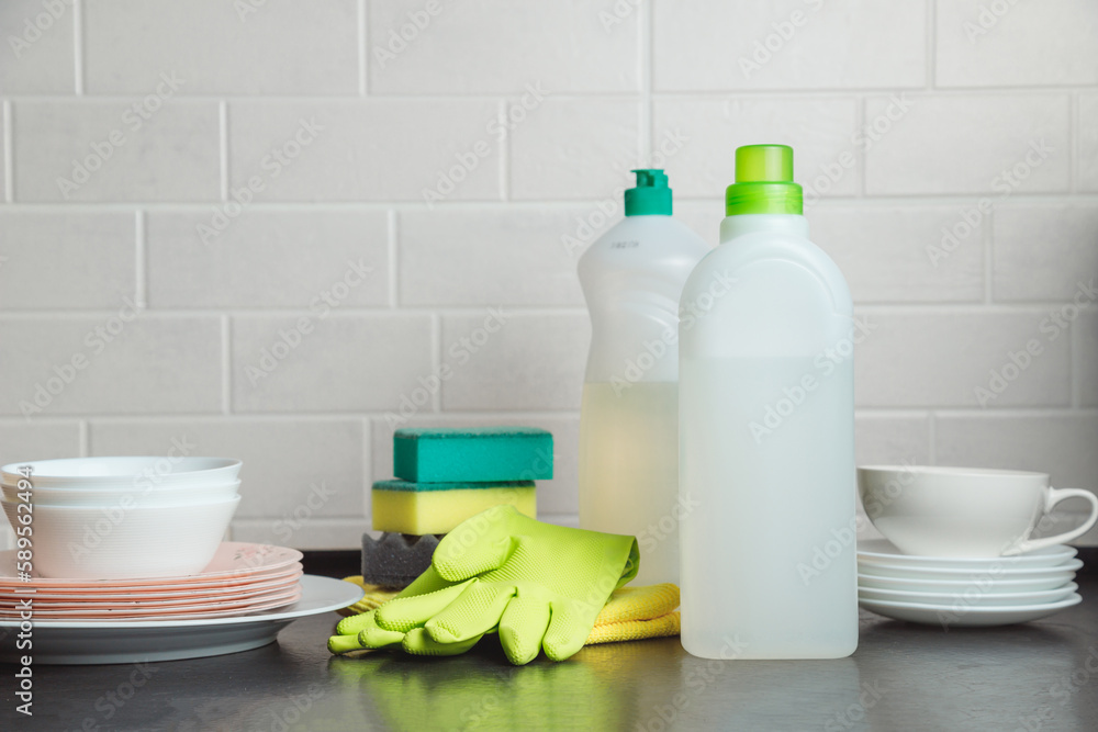Blank plastic bottle with liquid dishwashing detergent on kitchen table Blank plastic bottle with liquid dishwashing detergent on kitchen table