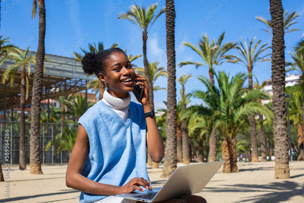 African student girl with her electric scooter enjoying in palm tree park