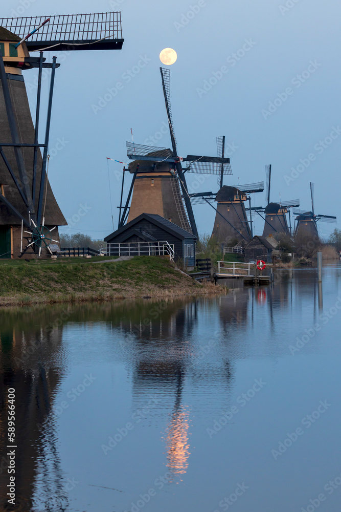 Moon over the historic windmills of Kinderdijk in Holland Moon over the historic windmills of Kinderdijk in Holland