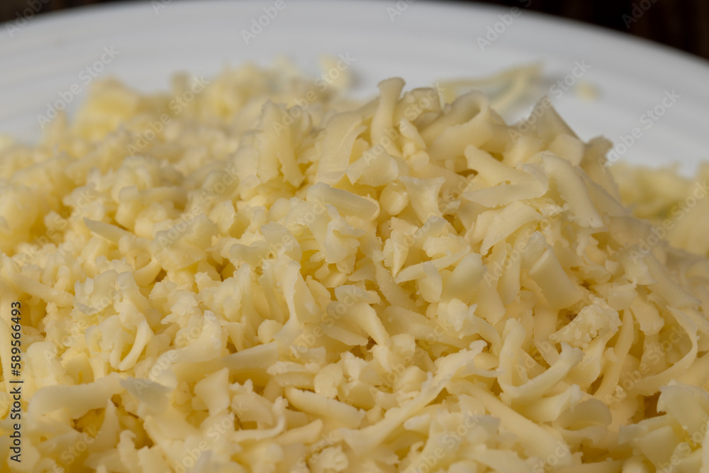Hard cheese with holes grated into thin small slices Hard cheese with holes grated into thin small slices
