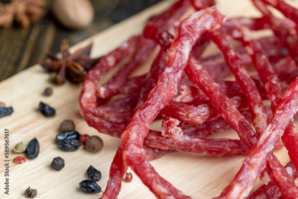 Dried veal sausage during slicing Dried veal sausage during slicing