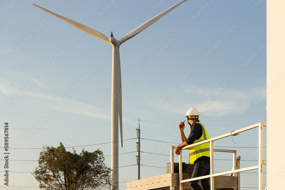 engineer team working in wind turbine farm. Renewable energy with wind generator by alternative energy concept.