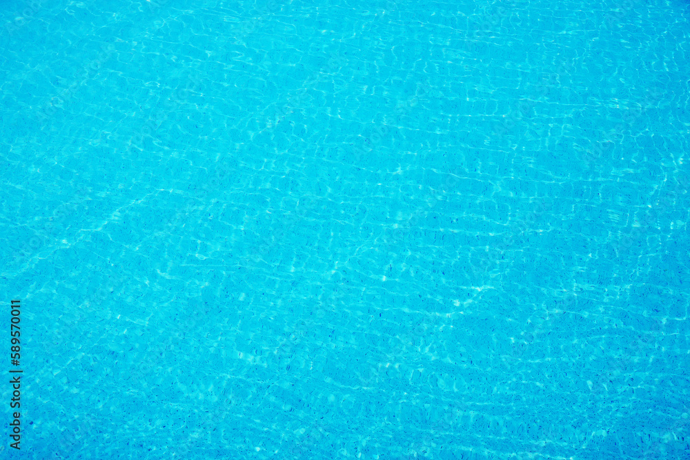 surface of ripple on blue water in swimming pool background.