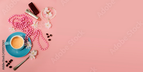 blue coffee cup with espresso, lipstick, necalce of pearls over romantic pink background with coffee space like good morning concept 