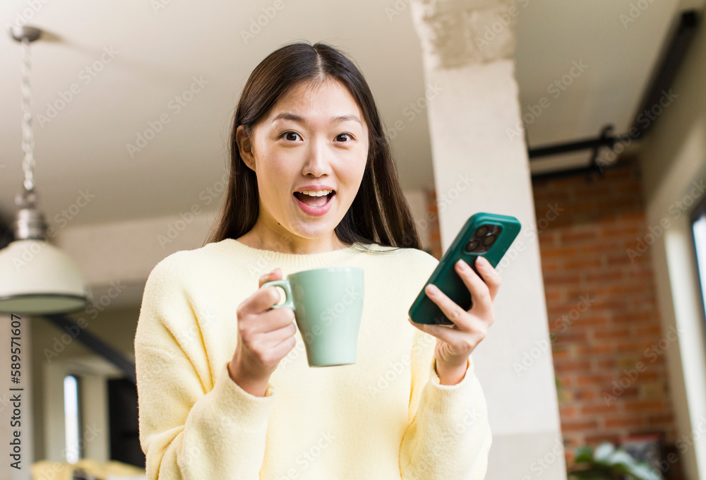 asian pretty woman using a smartphone in a cool home asian pretty woman using a smartphone in a cool home