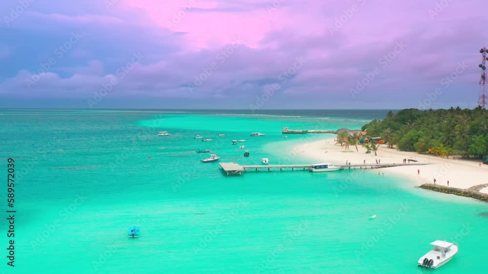 Aerial sunset view on turquoise sea with port in Fulidhoo island on Maldives. Landscape seascape and concept travel vacation Aerial sunset view on turquoise sea with port in Fulidhoo island on Maldives. Landscape seascape and concept travel vacation