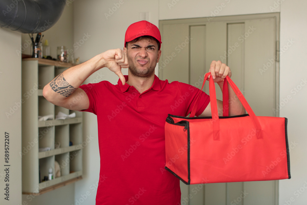 young handsome man feeling cross,showing thumbs down. pizza delivery concept young handsome man feeling cross,showing thumbs down. pizza delivery concept