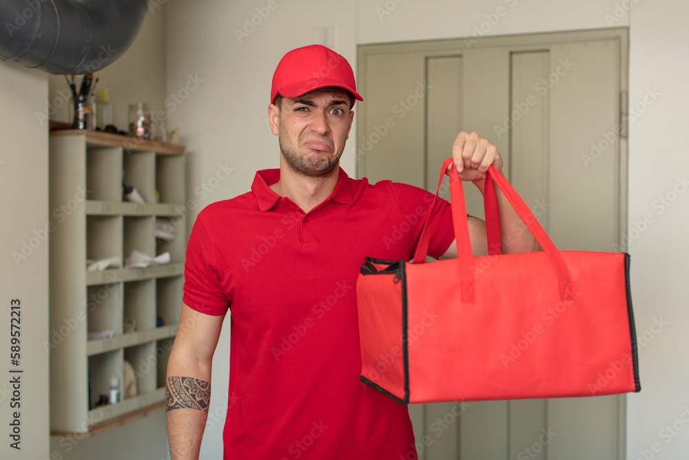 young handsome man feeling sad and whiney with an unhappy look and crying. pizza delivery concept young handsome man feeling sad and whiney with an unhappy look and crying. pizza delivery concept