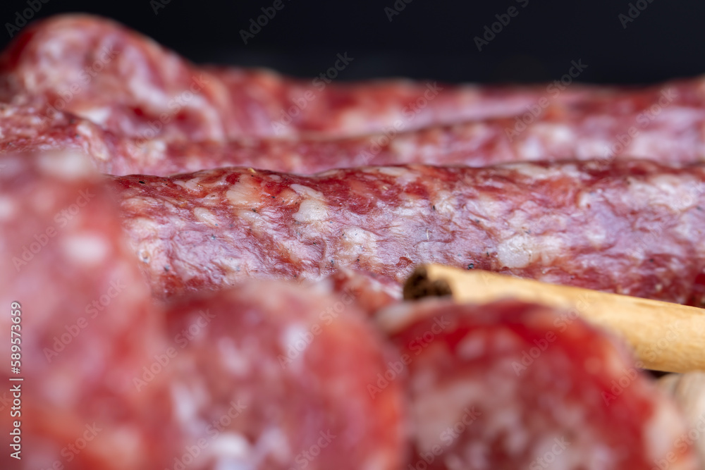 Dried veal sausage during slicing Dried veal sausage during slicing