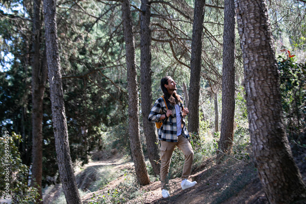 Long hair man in green forest Long hair man in green forest