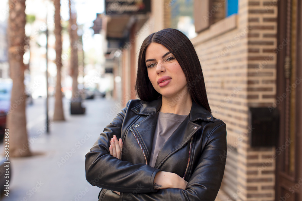 young pretty woman feeling displeased and disappointed, looking serious, annoyed and angry with crossed arms young pretty woman feeling displeased and disappointed, looking serious, annoyed and angry with crossed arms