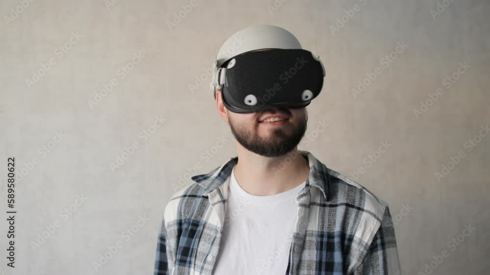 Handsome Man using 3D virtual reality headset.man wearing VR headset in living room. Handsome Man using 3D virtual reality headset.man wearing VR headset in living room.