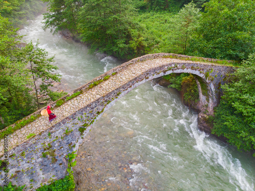 Old stone bridges and women carrying tea.