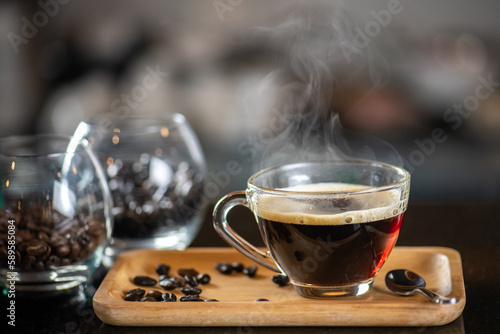 Photography black drip coffee in glass cup, Barista making drip coffee by pouring spills hot water on coffee bean