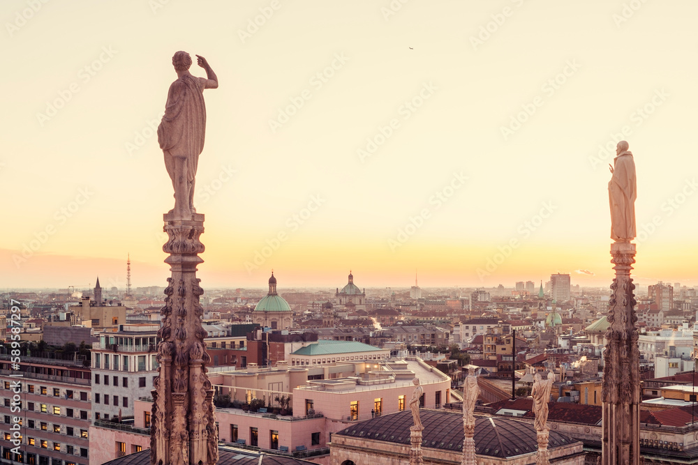 View of the statues on the Cathedral of Milan and the skyline of Milan seen on the background