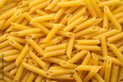 uncooked Penne rigate pasta for background.Top view